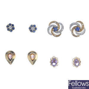 Eight pairs of earrings.