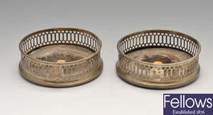 A pair of George III silver mounted wine coasters, plus two silver plated examples.
