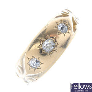 An early 20th century 18ct gold diamond three-stone band ring.