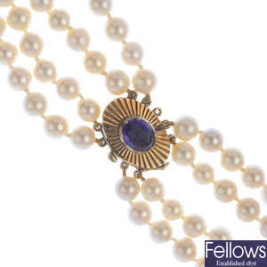 A cultured pearl four-row necklace with amethyst clasp.