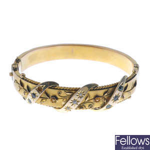 An Edwardian 9ct gold diamond and gem-set hinged bangle.