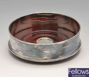 A modern silver mounted wine coaster, plus a matched set of six silver coasters.
