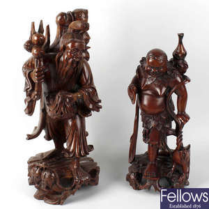 A box containing six Oriental carved rootwood figures.