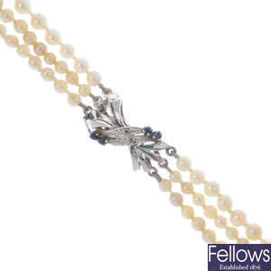 A 1960s cultured pearl three-strand necklace, with 18ct gold sapphire and diamond clasp.