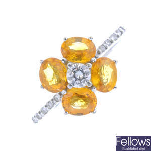 A diamond and citrine cluster ring.