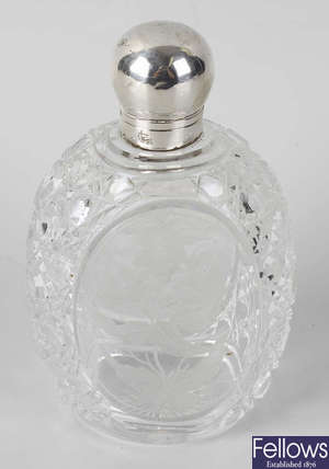 A cut glass flask, with oval panels to front and back, with etched decoration of flowers.
