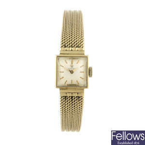 OMEGA - a lady's yellow metal bracelet watch.