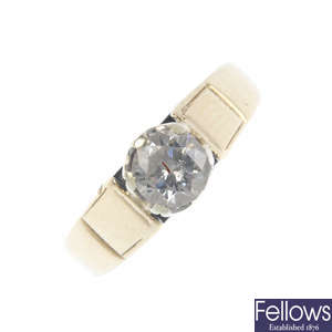 A gold diamond single-stone ring.