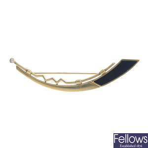 A 9ct gold diamond and onyx brooch.
