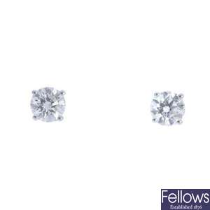 A pair of platinum brilliant-cut diamond single-stone earrings.