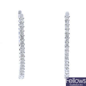 A pair of 9ct gold diamond hinged earrings.