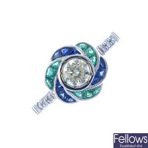 A diamond, emerald and sapphire cluster ring.