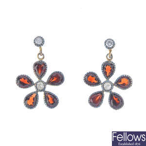 A pair of garnet and diamond ear pendants.