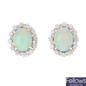 A pair of opal and diamond earrings.