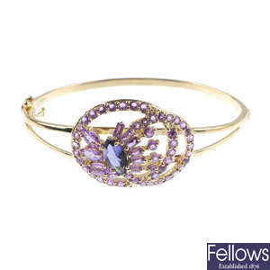 A 9ct gold iolite and sapphire hinged bangle.