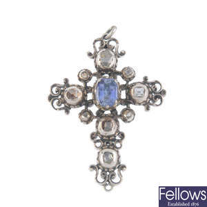 A synthetic sapphire and diamond cross pendant.