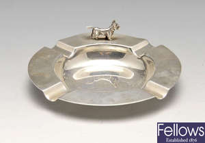 A 1920's silver ash tray, plus a silver wine taster and a silver trinket box.