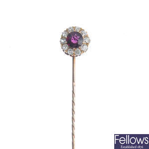 An early 20th century gold garnet and diamond cluster stickpin.