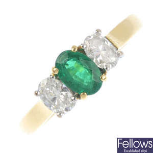 An 18ct gold emerald and diamond three-stone ring.