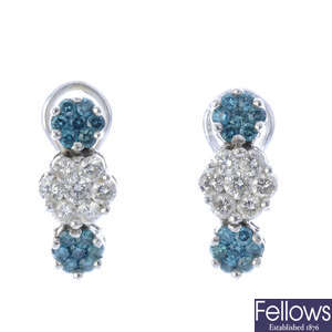 A pair of diamond and colour treated 'blue' diamond earrings.