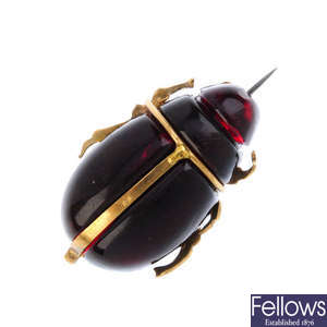 A paste scarab beetle brooch.