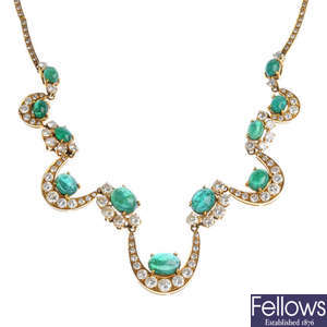An emerald and diamond necklace.