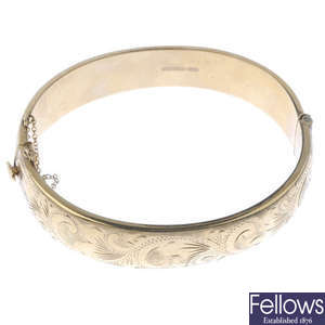 A mid 20th century 9ct gold hinged bangle.