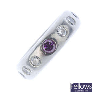 A colour treated 'purple' diamond and diamond band ring.