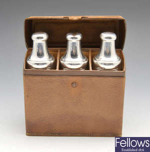 A cased set of three 1930's silver cased glass scent bottles.