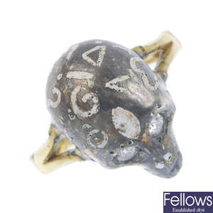 A diamond and enamel skull ring.
