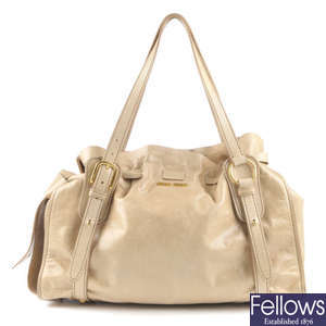MIU MIU - a cream leather Peggy Bow handbag.