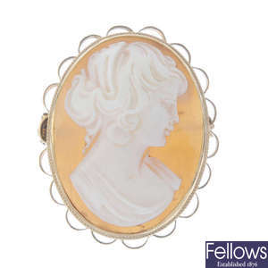 Two cameo brooches and a locket.