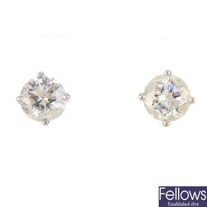 A pair of 18ct gold laser-drilled brilliant-cut diamond stud earrings.
