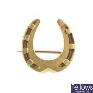 A late Victorian gold horseshoe brooch.