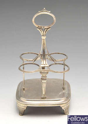 A George III silver bottle cruet stand.