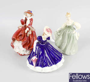 A group of nine Royal Doulton figurines.