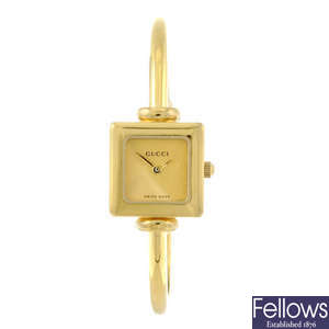 GUCCI - a lady's gold plated 1900L bracelet watch with a gentleman's Raymond Weil wrist watch.