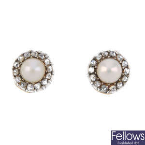 A pair of split pearl and diamond stud earrings.