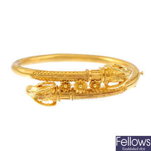 A mid Victorian gold Etruscan revival hinged bangle, circa 1870.