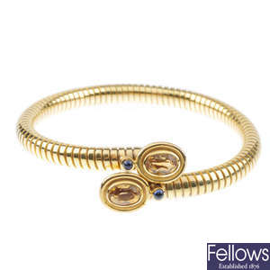 A 9ct gold citrine and sapphire bangle.