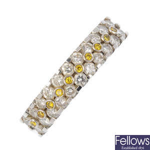 An 18ct gold colour treated 'yellow' diamond and diamond half-circle eternity ring.