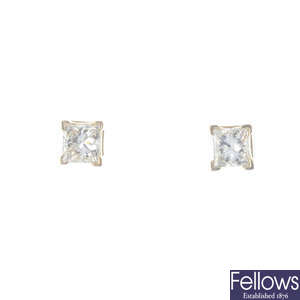 A pair of square-shape diamond stud earrings.