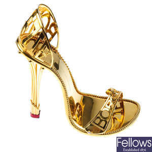 BORGEZIE - a pair of silver gilt stiletto shoes.
