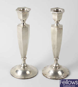 A pair of George V silver candlesticks.