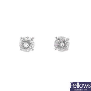 A pair of platinum brilliant-cut diamond single-stone stud earrings.
