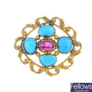 A turquoise and ruby brooch.