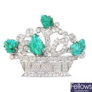 An emerald and diamond brooch.