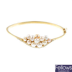 BOODLES & DUNTHORNE - a 14ct gold cultured pearl and diamond bangle.