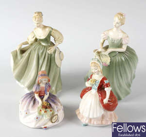 A group of four Royal Doulton figurines.