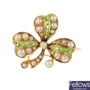 An Edwardian 15ct gold split pearl and demantoid garnet brooch.